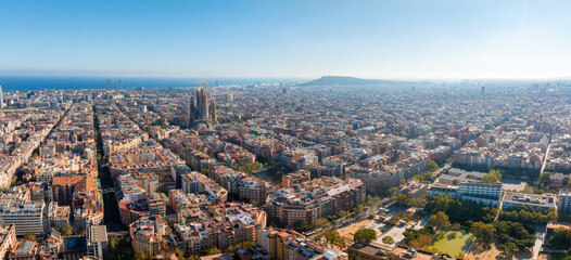 Aerial view of Barcelona City Skyline and Sagrada Familia Cathedral at sunset. Residential famous urban grid of Catalonia. Beautiful panorama of Barcelona.