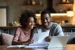 © senyumanmu - Man and woman couple smiling confident reading document at home