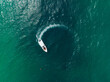 Aerial view of Speed boat in the aqua sea making a circle, Drone view.