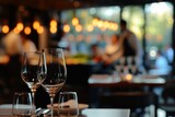 Fototapeta  - Elegant restaurant setting with blurred background of chefs and diners