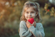 © ebhanu - little sincere adorable kid girl holding red heart on chest feeling gratitude pose