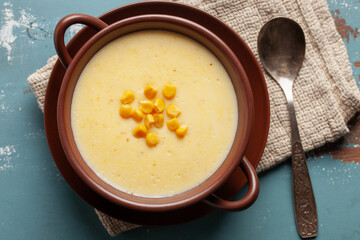 Wall Mural - Delicious creamy corn soup in ceramic bowl on the table. Vegetarian food