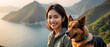 Background of sea and mountain views with a lovely smile from a tourist woman. Accompanied by her dog, the two share a close bond as best friends. At a mountain viewpoint.