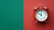 top view flat lay red alarm clock on green red background