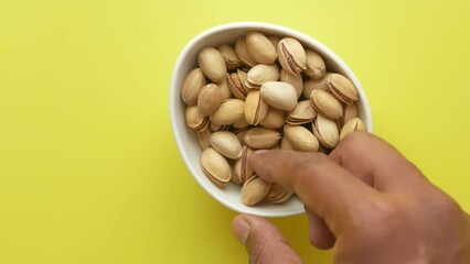 Poster - top view of hand picks pistachios nuts