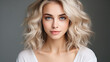 © TAMA KUN - Portrait of a beautiful young woman with blond curly hair and makeup.