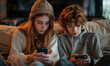 © Irina - teen siblings playing mobile game
