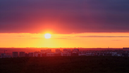 Wall Mural - Sunset creates a colorful background with orange and red clouds in the evening sky.