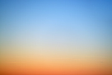 Wall Mural - The gradient of the sunset sky from red-orange to blue