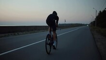 Strong Triathlete Cyclist Training On Bicycle	