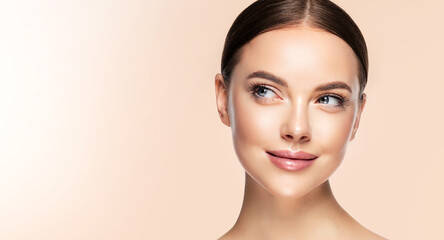 beautiful young woman with clean fresh skin touching her face . girl facial treatment . cosmetology 