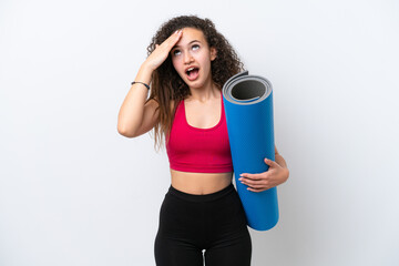 Wall Mural - Young sport Arab woman going to yoga classes while holding a mat isolated on white background doing surprise gesture while looking to the side