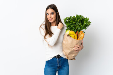 Canvas Print - Young caucasian woman buying some food isolated on white background celebrating a victory