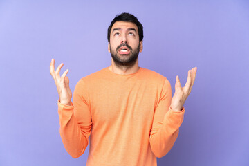 Wall Mural - Caucasian handsome man over isolated purple background frustrated by a bad situation
