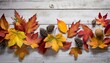 fall and autumn leaves on a whitewashed wood plank board