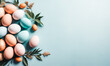 © Roman - Festive Easter Eggs and Leaves on Light Blue Background, Flat Lay. Space for Text . Easter holiday