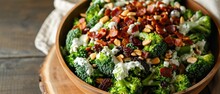 A Broccoli And Bacon Salad With Blanched Broccoli Florets, Crispy Bacon, Raisins, Sunflower Seeds, And A Creamy Dressing
