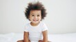 © Kate - portrait of a small dark-skinned baby 1 year old in a diaper on a white studio background, copy space