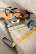 Rubber hammer, ruler with angle bar, tape meter, jig saw and other tools for installation of laminate vinyl floor. Home improvement, new floor installation.	