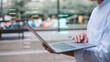 © cherdchai - businessman using computer laptop outdoor with virtual document icon in concept of document and data analysis