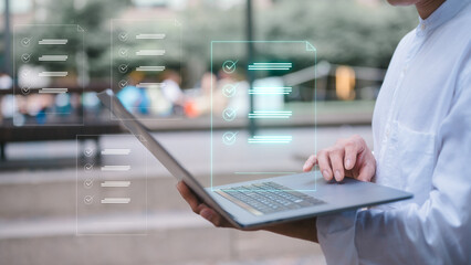 businessman using computer laptop outdoor with virtual document icon in concept of document and data analysis