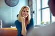 © Marko Geber - Young smiling businesswoman talking to colleague in office