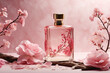 Rectangular mockup of a perfume bottle in pink tones, splashes of water, pink flowers on tree branches