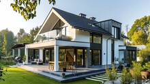 White Family House With Black Pitched Roof Tiles