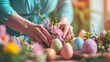 A close-up of a woman's hands as she carefully arranges Easter-themed table decorations