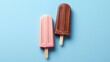 Ice creams on a stick of different colors and flavors are lined up on a light green background. Concept: Children's summer treat. Cold dessert without sugar or substitutes. Copy space
