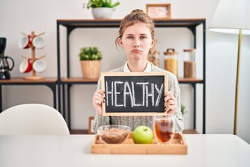 Poster - Troubled young blonde woman expressing stress, worry, and anger over breakfast at home; her sad, crying face reflecting a depressive state and indicating distressed signs on her blackboard.