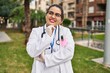© Krakenimages.com - Young beautiful plus size woman doctor smiling confident standing with arms crossed gesture at park
