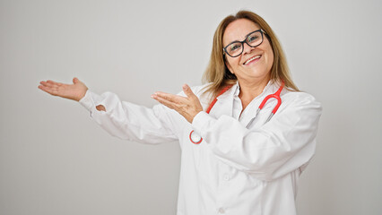 Wall Mural - Middle age hispanic woman doctor smiling confident presenting over isolated white background