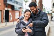 © Krakenimages.com - Man and woman couple smiling confident using smartphone at street