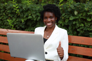 Sticker - successful african female working with laptop with hand gesture	