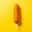 Corn dog on a yellow background.