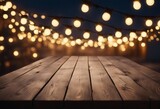 Empty Wood table top with decorative outdoor string lights at night time Empty wood table top with b