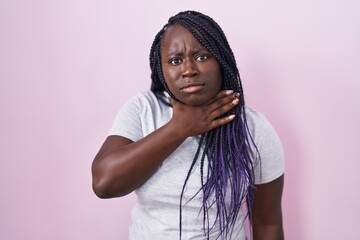 Poster - Young african woman standing over pink background cutting throat with hand as knife, threaten aggression with furious violence