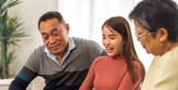 Fototapeta  - Portrait enjoy happy smiling love asian family.Senior mature father hug with elderly mother and young adult woman play laughing and having fun together at home.insurance concept