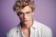 © MaskaRad - portrait of a blond young guy with glasses in a beautiful frame. optics, vision correction and eye imperfections. modern eyeglasses for vision.