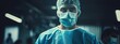 Surgeon man with blue medical uniform in operating room. Portrait of a surgeon in a hospital
