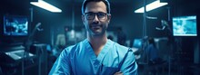 Surgeon Man With Blue Medical Uniform In Operating Room. Portrait Of A Surgeon In A Hospital