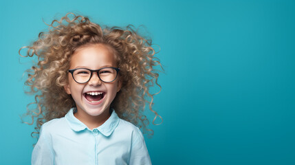 Wall Mural - Happy little curly blonde girl isolated on blue background