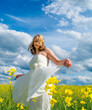 © funkenzauber - attractive woman with white dress in a rap field