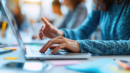 Person is typing on a laptop with lines of code visible on the screen