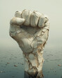 © Madeleine Steinbach - Victory hand in the form of clenched fist emerging out of water, with broken porcelain effect