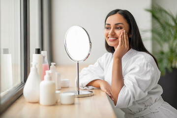 Wall Mural - Beautiful young indian woman looking at mirror