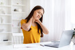 © Prostock-studio - Tired Asian Freelancer Woman With Neck Pain Sitting At Desk With Laptop