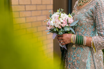 Canvas Print - Indian bride's holding beautiful wedding flowers bouquet close up