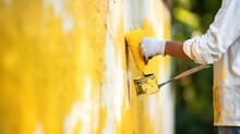  A Man Is Painting A Yellow Wall With A Yellow Paint Roller And A Yellow Paint Can With A Yellow Brush.